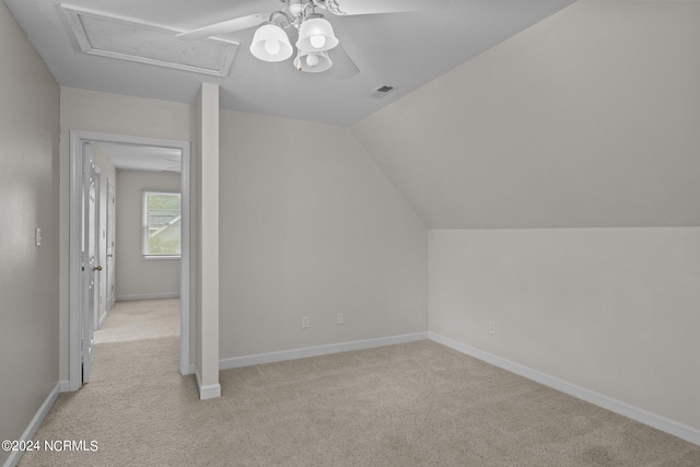 additional living space featuring ceiling fan, lofted ceiling, and light carpet