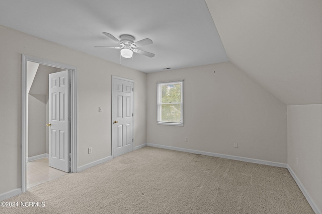 bonus room featuring ceiling fan, lofted ceiling, and light carpet