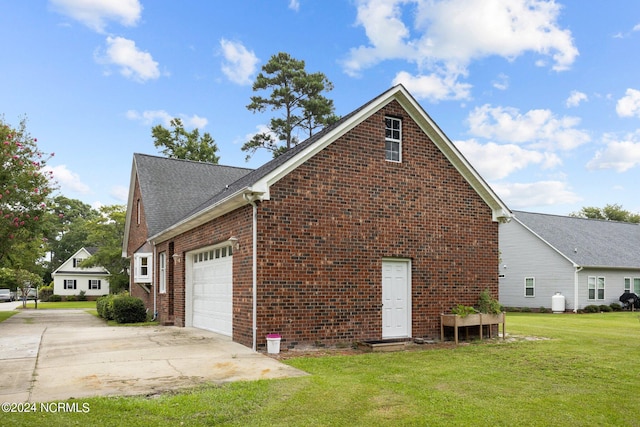 view of side of home featuring a garage and a lawn