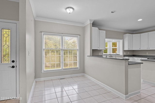 kitchen featuring white cabinetry, light tile patterned floors, and a healthy amount of sunlight