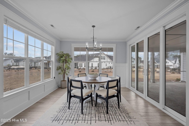 sunroom with a chandelier, french doors, and visible vents