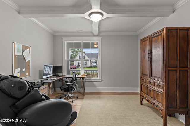 office space with ornamental molding, light wood finished floors, beamed ceiling, and baseboards