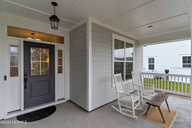 view of exterior entry with covered porch