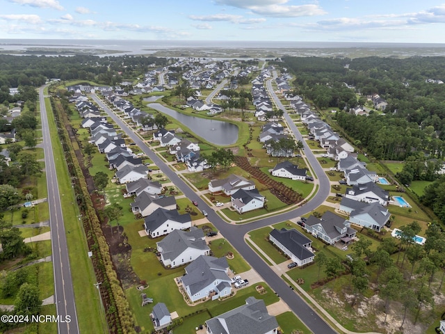 birds eye view of property with a water view and a residential view