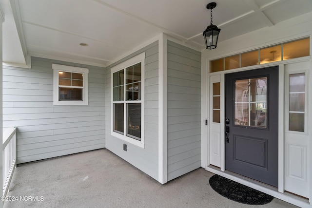 entrance to property featuring a porch