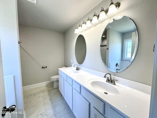 full bath featuring marble finish floor, a sink, baseboards, and toilet