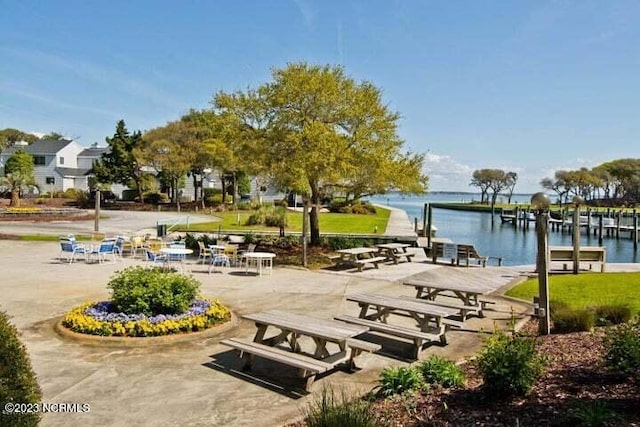 view of property's community featuring a water view and a patio