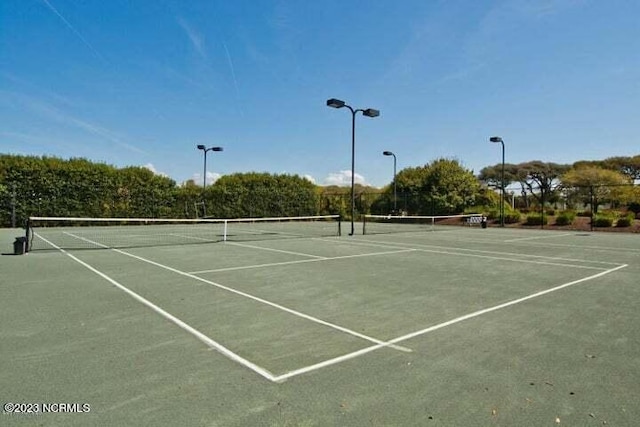 view of tennis court with fence