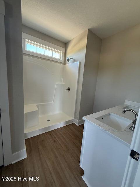 304 Old Swamp Rd, South Mills, NC 27976 - bathroom featuring a shower, wood finished floors, baseboards, and vanity