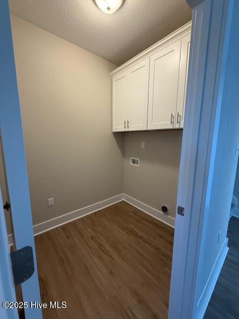 304 Old Swamp Rd, South Mills, NC 27976 - clothes washing area featuring cabinet space, hookup for a washing machine, baseboards, dark wood-type flooring, and a textured ceiling