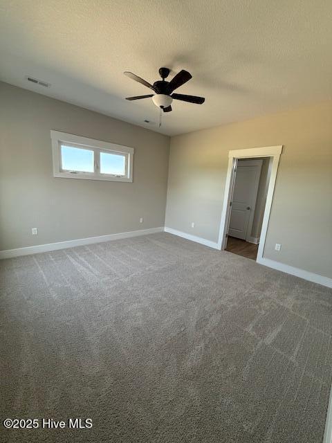 304 Old Swamp Rd, South Mills, NC 27976 - spare room featuring baseboards, dark carpet, ceiling fan, and a textured ceiling