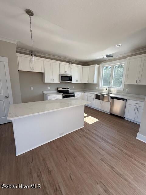 304 Old Swamp Rd, South Mills, NC 27976 - kitchen with appliances with stainless steel finishes, white cabinets, a sink, dark wood-type flooring, and a center island