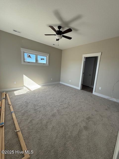 interior space with ceiling fan and carpet flooring