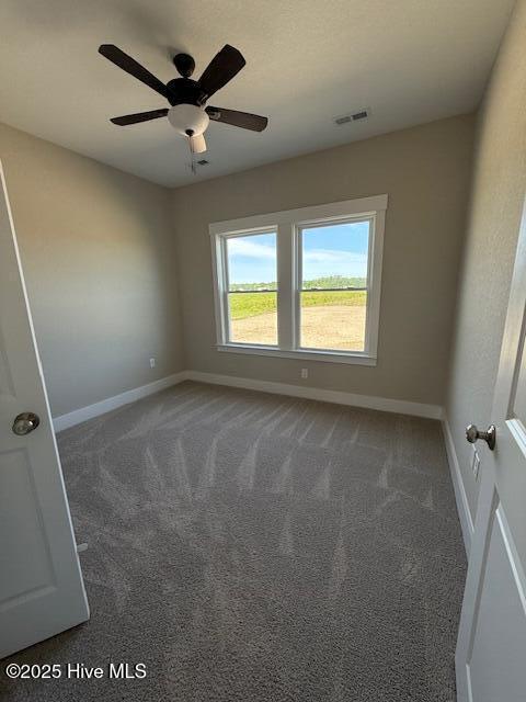 304 Old Swamp Rd, South Mills, NC 27976 - unfurnished room with baseboards, carpet flooring, and ceiling fan
