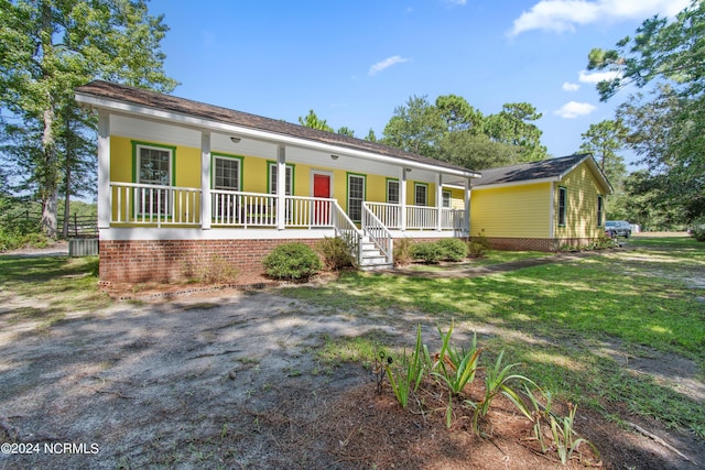 ranch-style house with a front yard and a porch