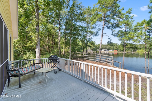 wooden terrace featuring a water view