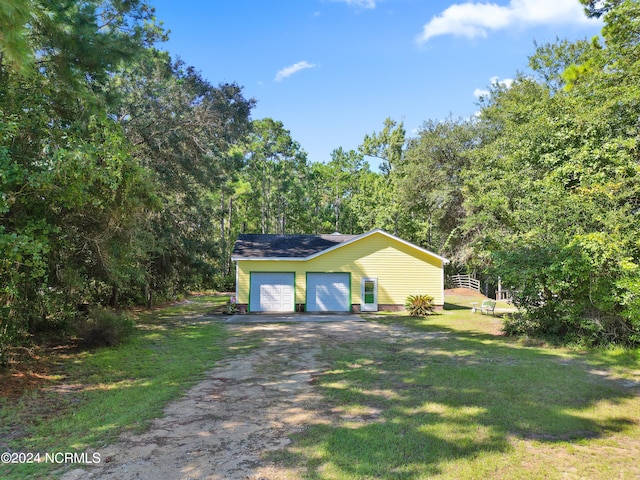 view of front of house with a front yard and a garage