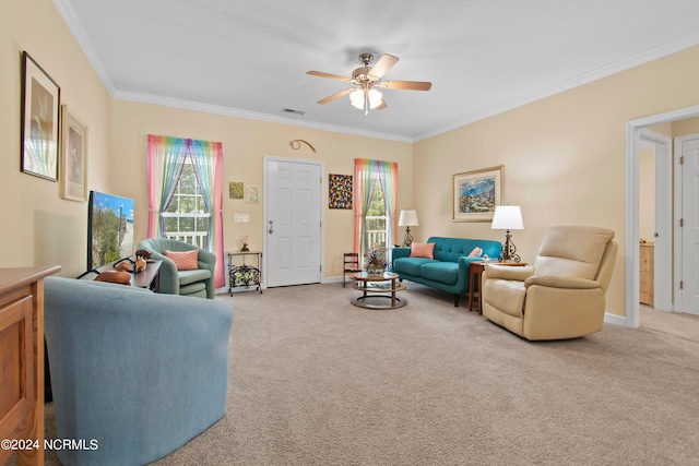 carpeted living room featuring ceiling fan and ornamental molding