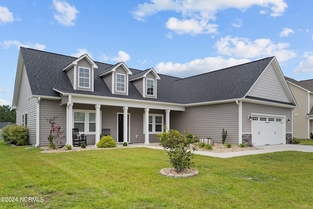 new england style home featuring a porch, a garage, and a front yard