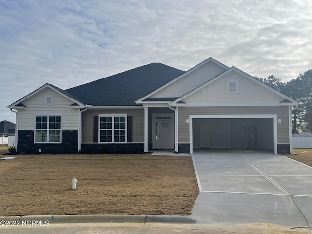 view of front of property with a garage and a front yard