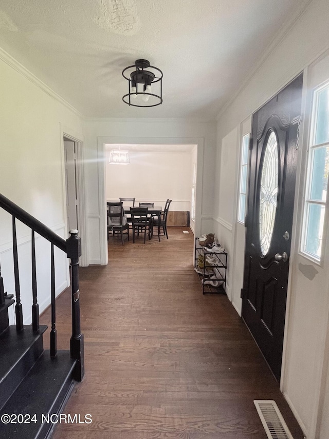 entryway with crown molding and hardwood / wood-style flooring