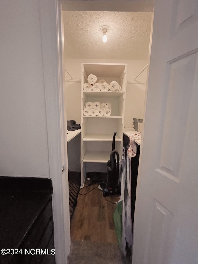 spacious closet featuring hardwood / wood-style floors