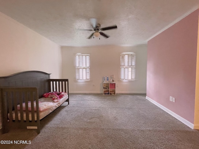 bedroom with carpet floors, crown molding, a textured ceiling, and ceiling fan