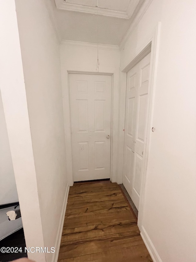 hall with hardwood / wood-style floors and crown molding