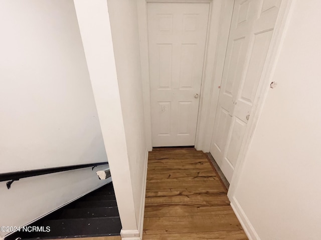 corridor with hardwood / wood-style floors