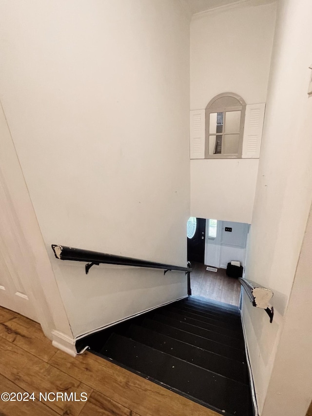 staircase featuring hardwood / wood-style floors