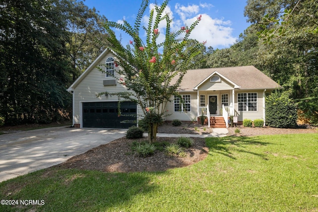 view of front of property with a front yard, cooling unit, and a garage