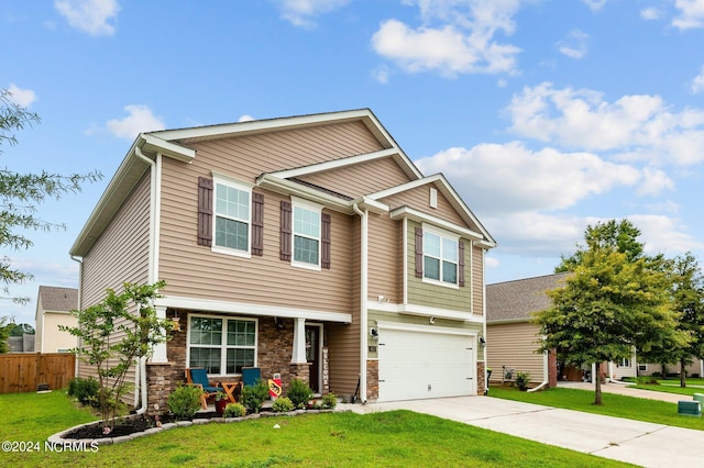 craftsman-style home featuring an attached garage, fence, concrete driveway, stone siding, and a front lawn