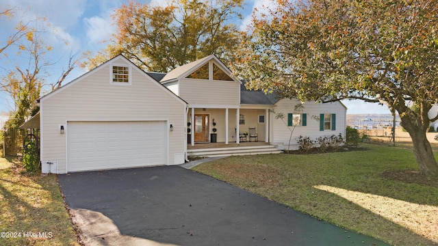 511 N A St, Bridgeton, NC 28519 - view of front facade with asphalt driveway, covered porch, an attached garage, and a front lawn