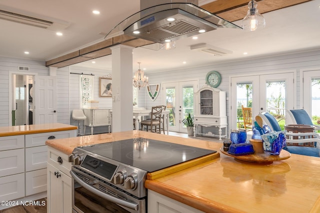 511 N A St, Bridgeton, NC 28519 - kitchen with stainless steel range with electric stovetop, french doors, ornamental molding, a barn door, and white cabinetry