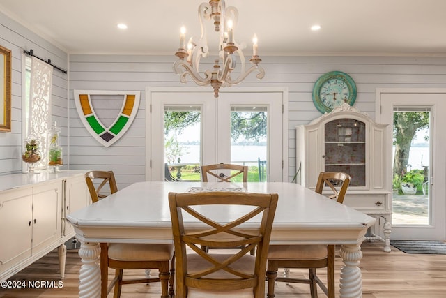 511 N A St, Bridgeton, NC 28519 - dining space with healthy amount of natural light, light wood-style floors, a chandelier, ornamental molding, and wood walls