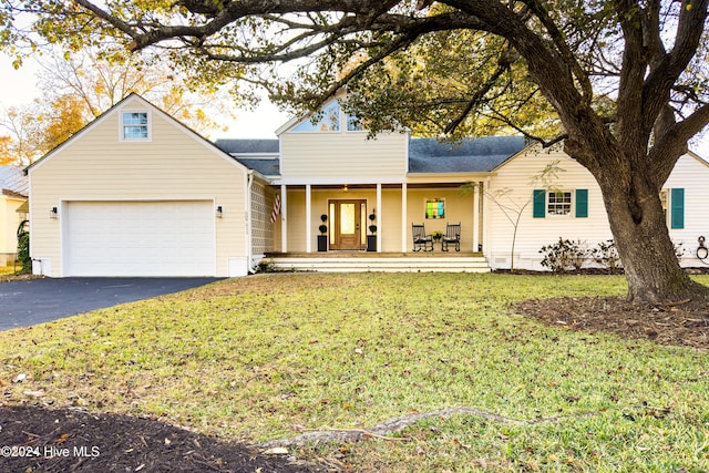 511 N A St, Bridgeton, NC 28519 - view of front of property with covered porch, driveway, a front yard, and an attached garage