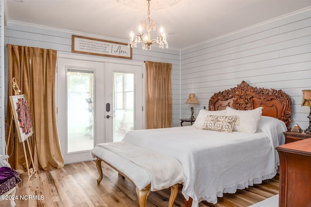 511 N A St, Bridgeton, NC 28519 - bedroom with crown molding, a chandelier, access to outside, wood finished floors, and wood walls