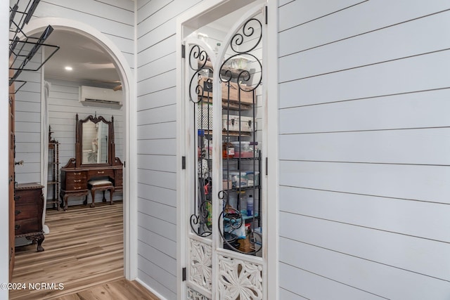 511 N A St, Bridgeton, NC 28519 - hall featuring wooden walls, light wood-style floors, a wall mounted AC, and arched walkways