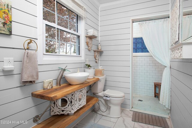 511 N A St, Bridgeton, NC 28519 - full bath featuring toilet, a tile shower, marble finish floors, wooden walls, and a sink