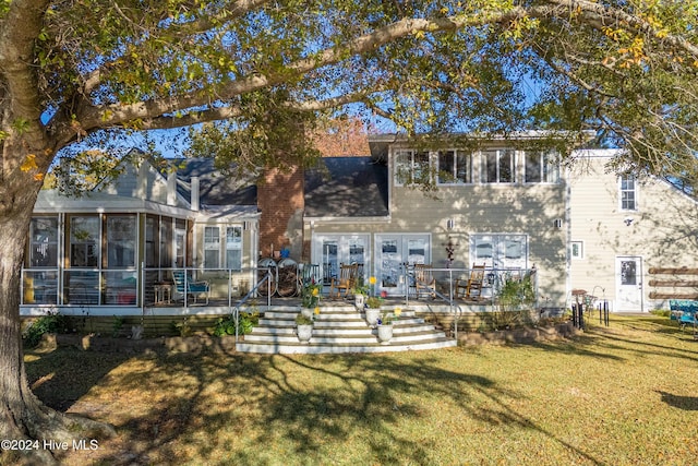 511 N A St, Bridgeton, NC 28519 - back of property with a sunroom, a lawn, stairway, and a chimney