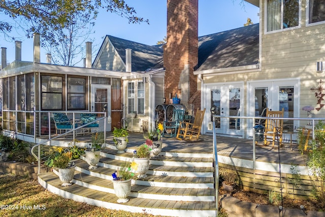 511 N A St, Bridgeton, NC 28519 - back of house with a chimney, a sunroom, french doors, and roof with shingles