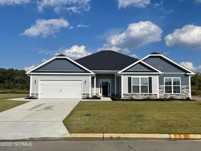 craftsman-style home featuring a garage and a front yard