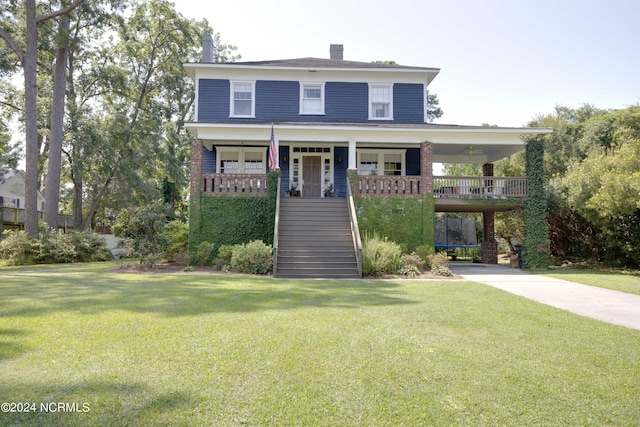 view of front facade with covered porch, a chimney, a front lawn, and stairs