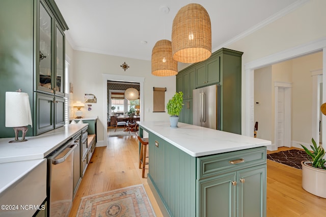 kitchen with pendant lighting, high quality fridge, green cabinetry, and light wood-type flooring