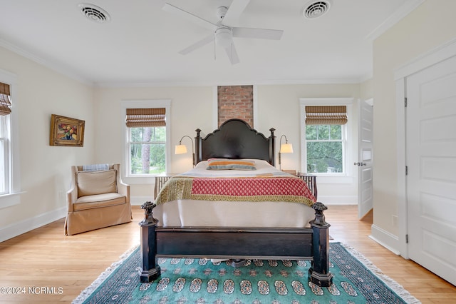 bedroom featuring multiple windows, hardwood / wood-style floors, crown molding, and ceiling fan