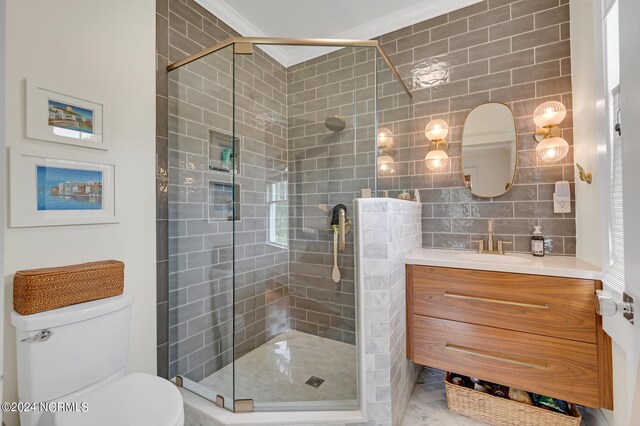 bathroom with decorative backsplash, vanity, toilet, a shower with door, and crown molding