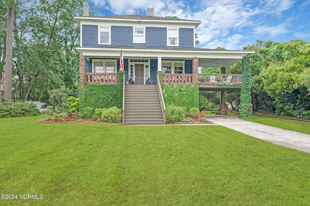 view of front of property featuring a porch, a carport, and a front yard