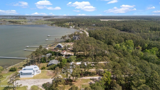 aerial view featuring a wooded view and a water view