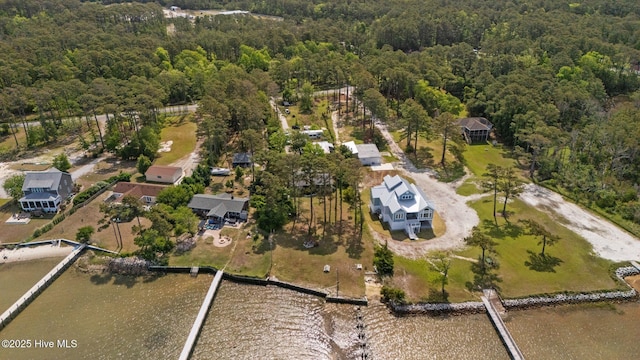 drone / aerial view featuring a water view and a view of trees