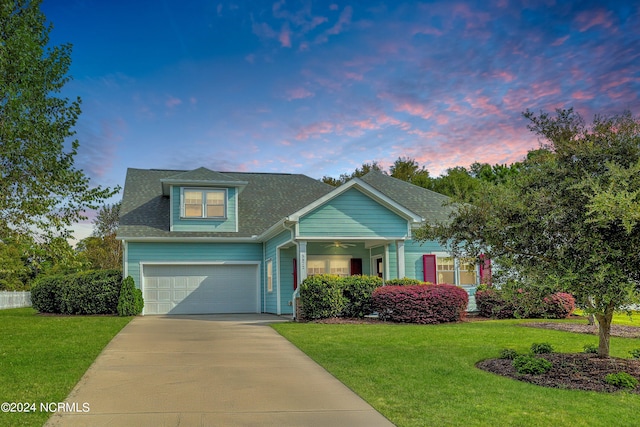 view of front of property featuring a yard and a garage